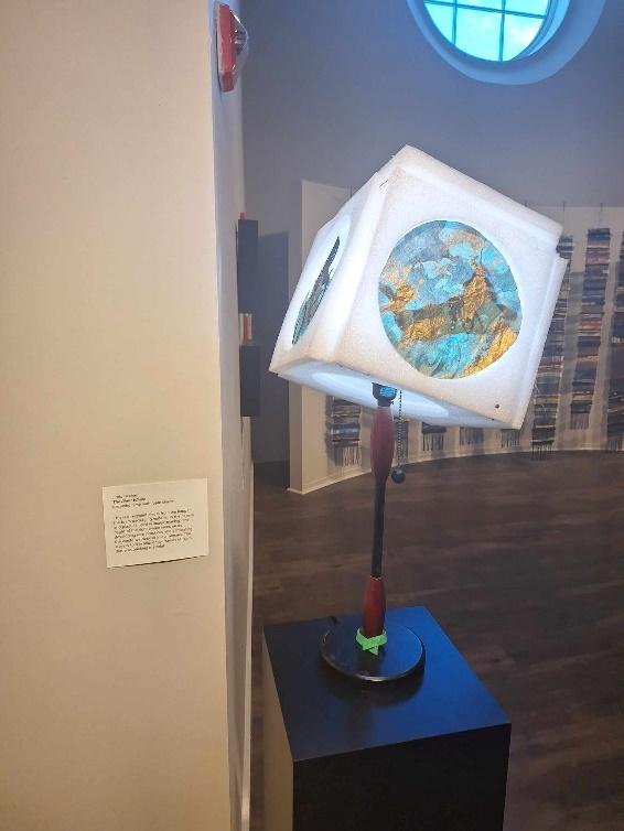 A lamp with a globe on it
Description automatically generated