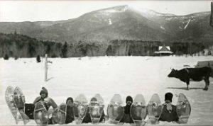 Snowshoers from the Waterville Valley Athletic & Improvement Association posing in front of Mt. Osceola