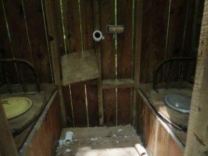 Inside an outhouse with two seats