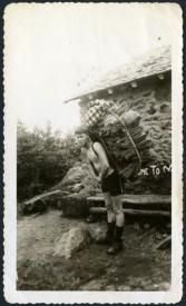 Arthur L. “Bud” Coburn packing blankets out of Madison Hut, circa 1918
