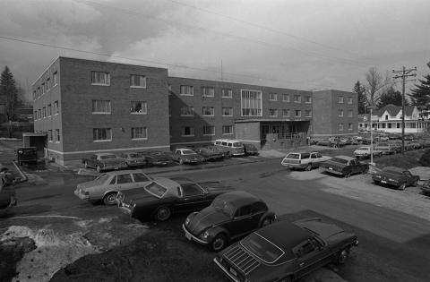 Plymouth State in 150 exhibition 1960s Blair Hall building and parking lot