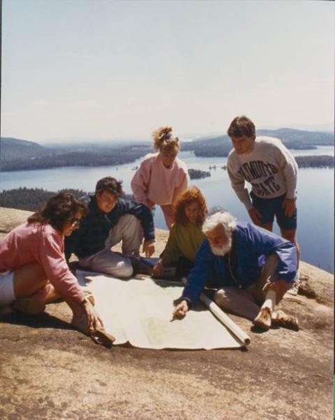 Plymouth State in 150 Objects exhibition 1980s professor John Dow at Rattlesnake mountain with students