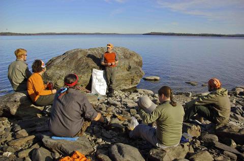 Plymouth State in 150 Objects exhibition 2000s class out on rocks by water
