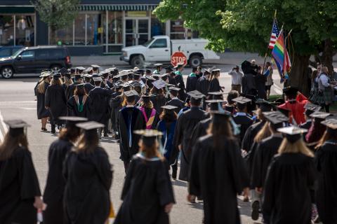 Plymouth State in 150 Objects exhibition 2010s commencement procession across a street