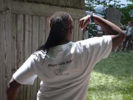 An Ordway camper from the back doing a bicep pose