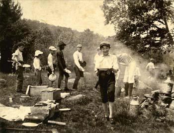 Young campers with plates at a campfire at Groton School Camp.