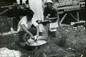 Groton School Campers washing clothes in a basin