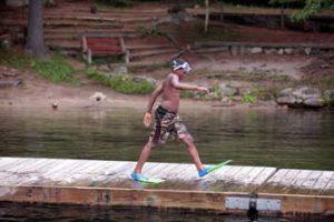 swimmer walking on a dock at Camp Hale
