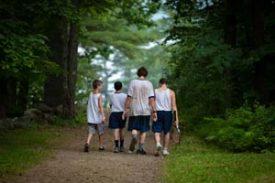 Young campers walking down a trail