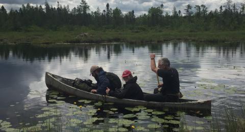 Len Reitsma, Sam Parks, and Autumn Heil in canoe on lake