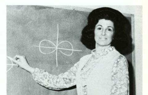 Old black and white photo that appears to show a young woman, Barbara Dearborn, standing at a chalkboard