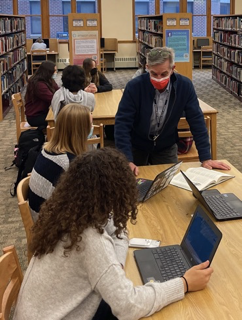 Mark instructs students about information literacy.