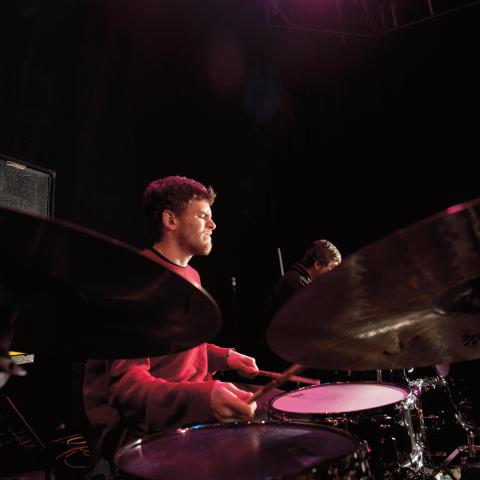 student playing drums