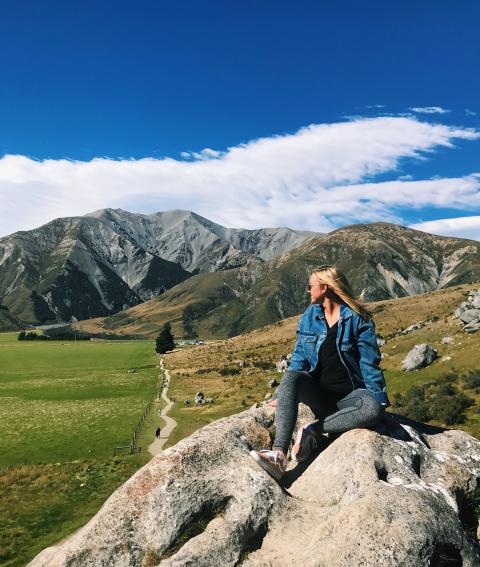 Overseas student with mountains in the distance.